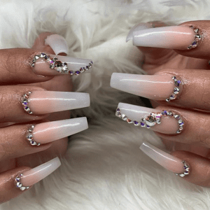 Long white nails with silver and purple rhinestones.