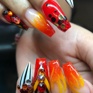 A hand with long red and orange flame-like nails.